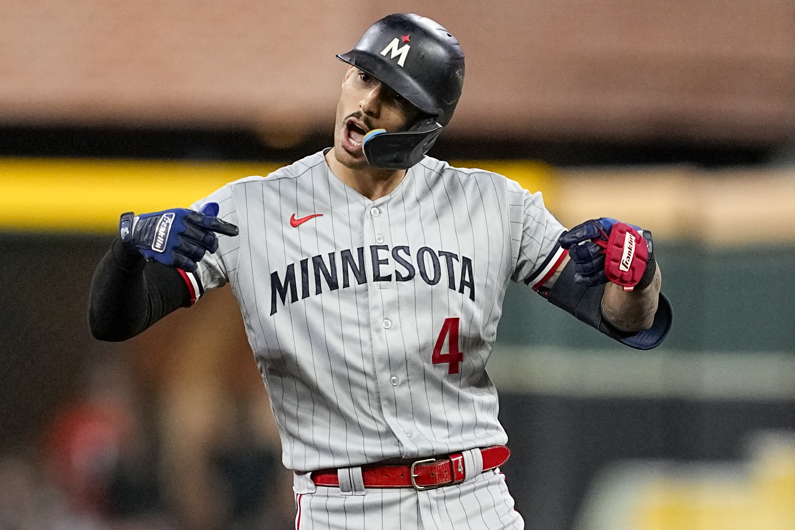 Minnesota Twins' Carlos Correa celebrates after a RBI-double against the Houston Astros during the first inning in Game 2 of an American League Division Series baseball game in Houston, Sunday, Oct. 8, 2023. (AP Photo/Tony Gutierrez)